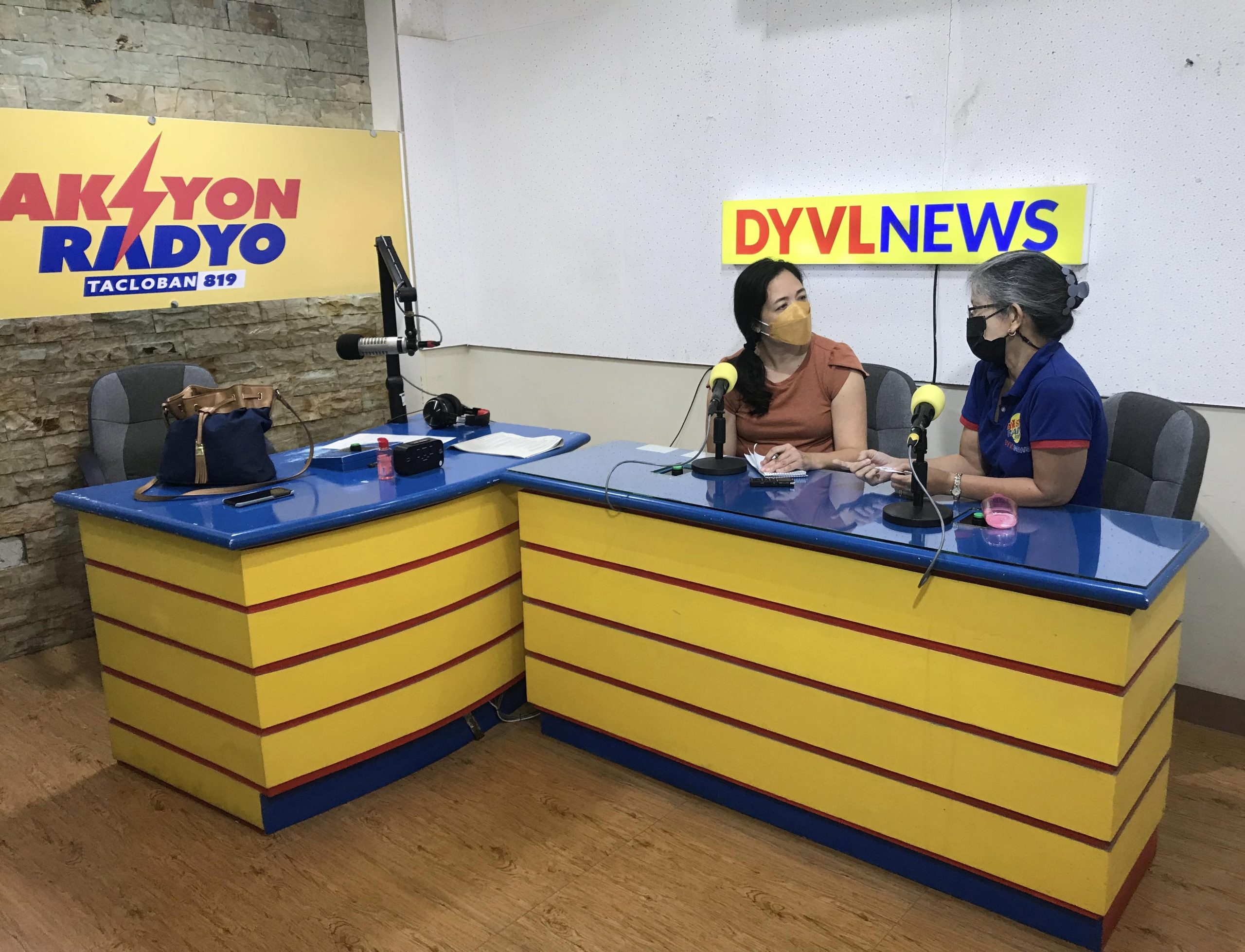 Shanahan talks with veteran radio journalist Louie Quebec at the DYVL studio in Tacloban City, Philippines.